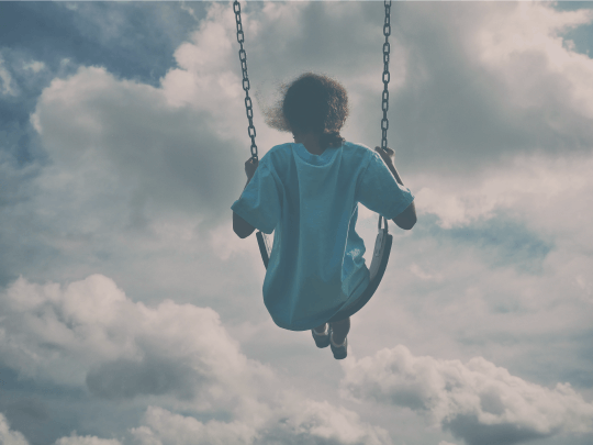 A child playing on a swing