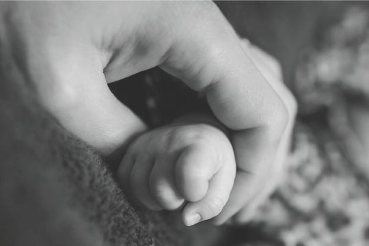 Baby and mother's hands, surrogacy